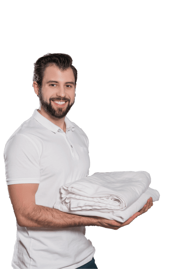 dry cleaning worker holding stack of clean clothes JV22ME2