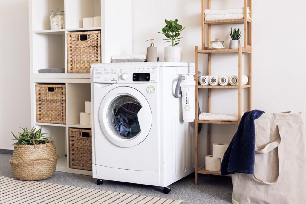 Laundry room with washing machine and organized laundry supplies
