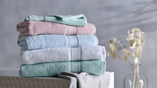 Neatly folded clean towels in various colors for fresh laundry